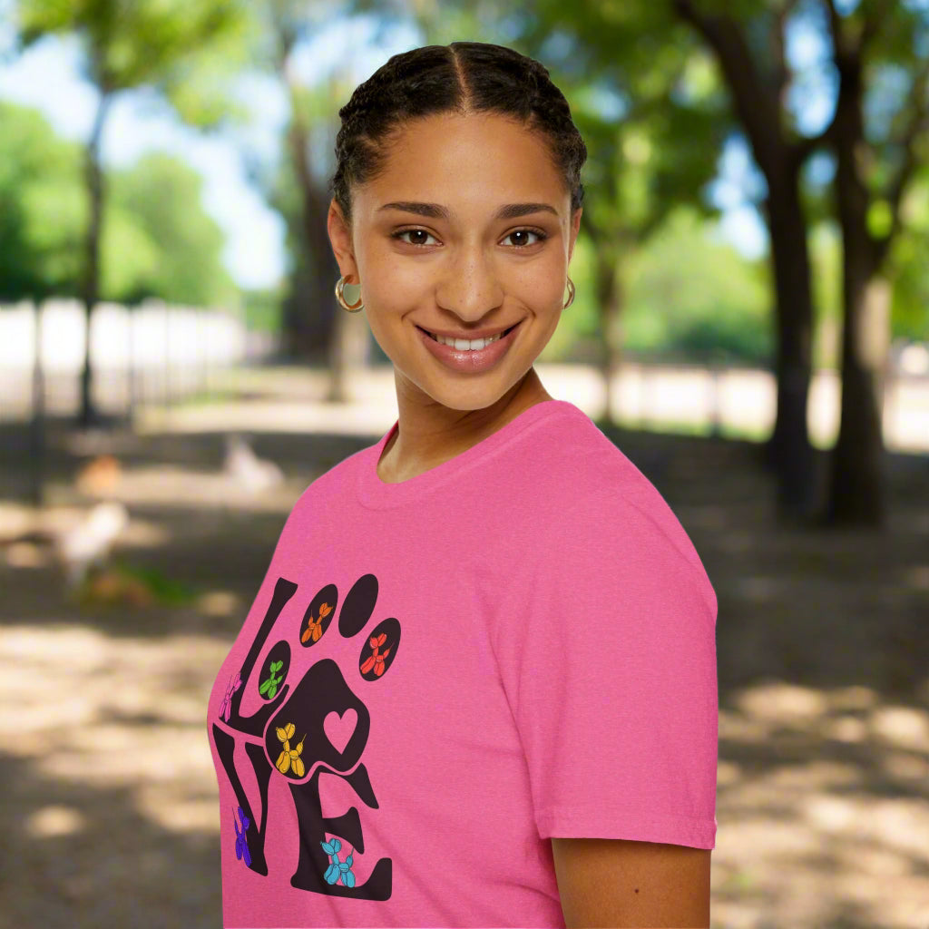 Person wearing a pink t-shirt with a colorful paw design on a white background
