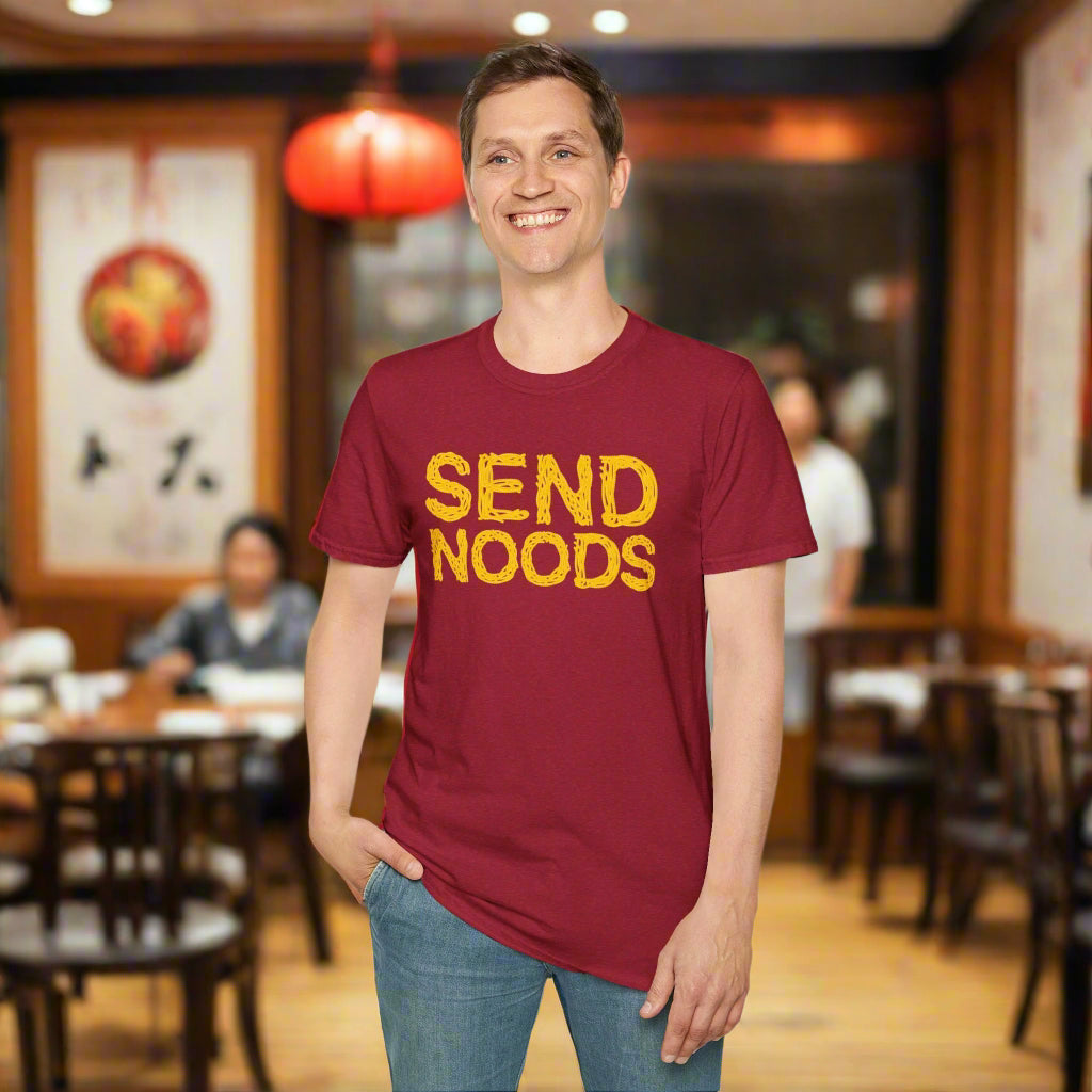 Person wearing a red t-shirt with 'SEND NOODS' in yellow text on a white background