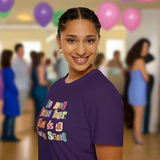 Person wearing a purple t-shirt with colorful text on a white background