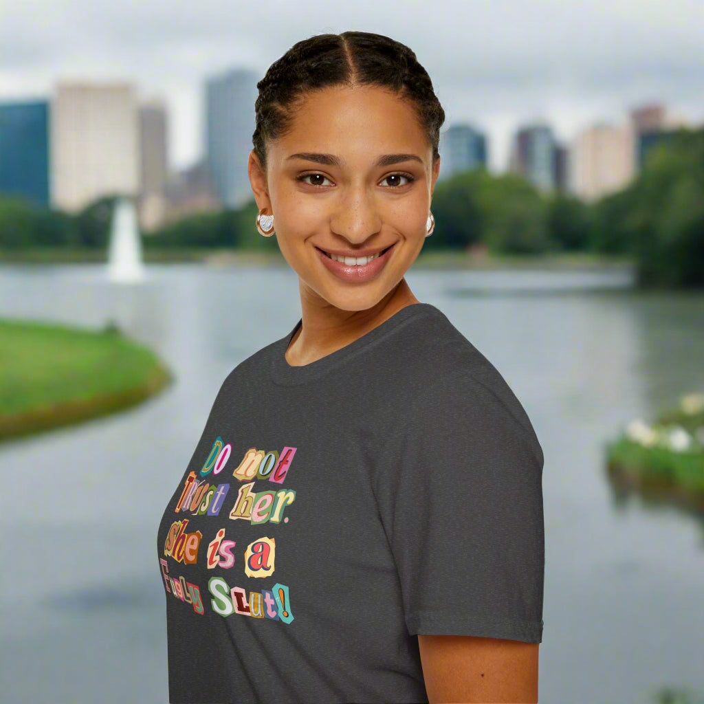 Person wearing a gray t-shirt with colorful text design on a white background