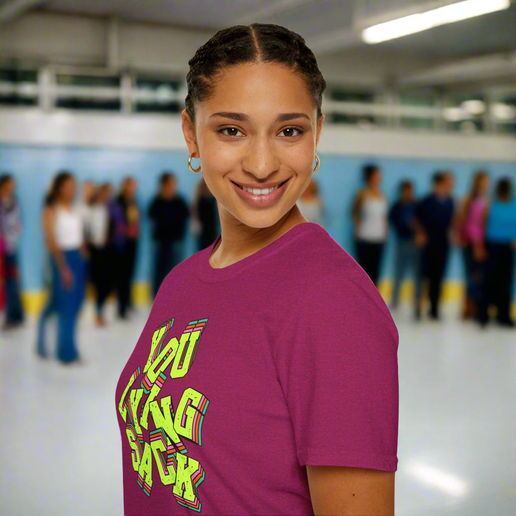 Person wearing a purple t-shirt with colorful text design on a white background