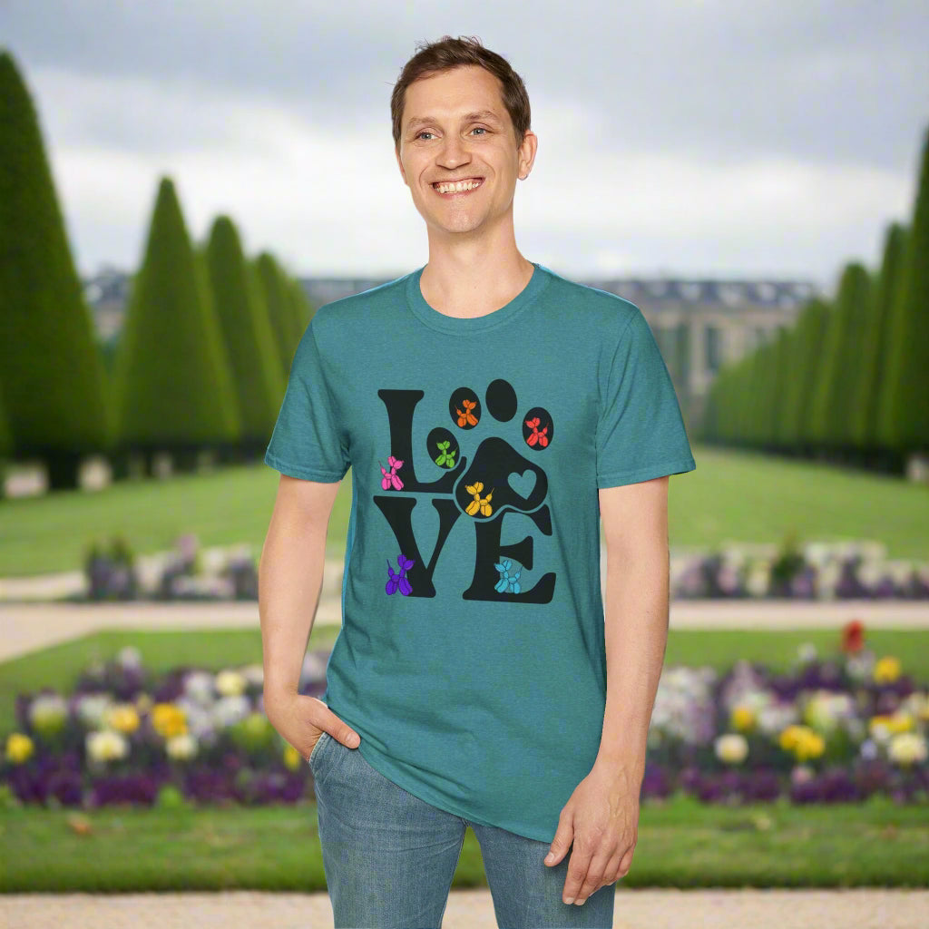 Person wearing a teal t-shirt with a colorful paw print design on a white background