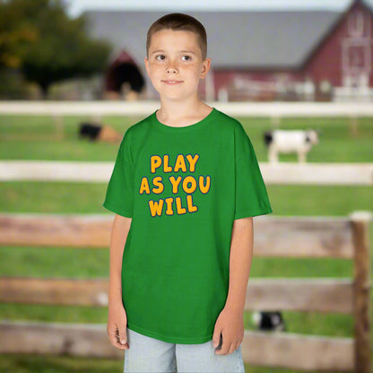 Child wearing a green t-shirt with 'Play as You Will' text on a white background