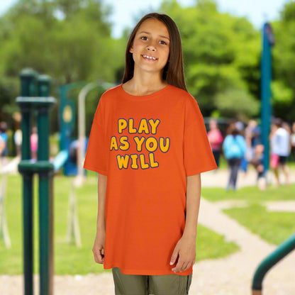 Child wearing an orange t-shirt with 'Play as You Will' text on a white background