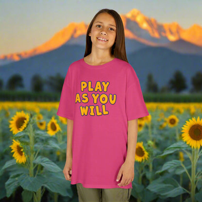 Young girl wearing a pink t-shirt with 'Play as You Will' text on a white background